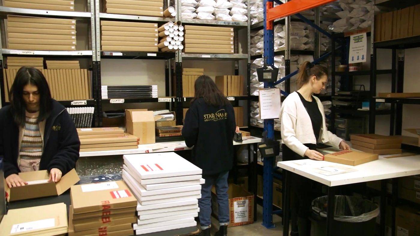 Team assembling personalised orders at packing benches
