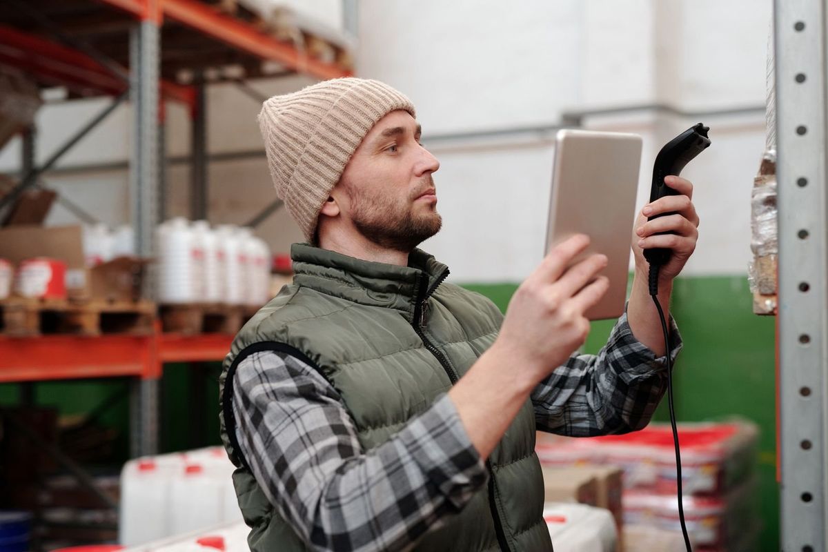 Warehouse worker scanning stock for pick and pack