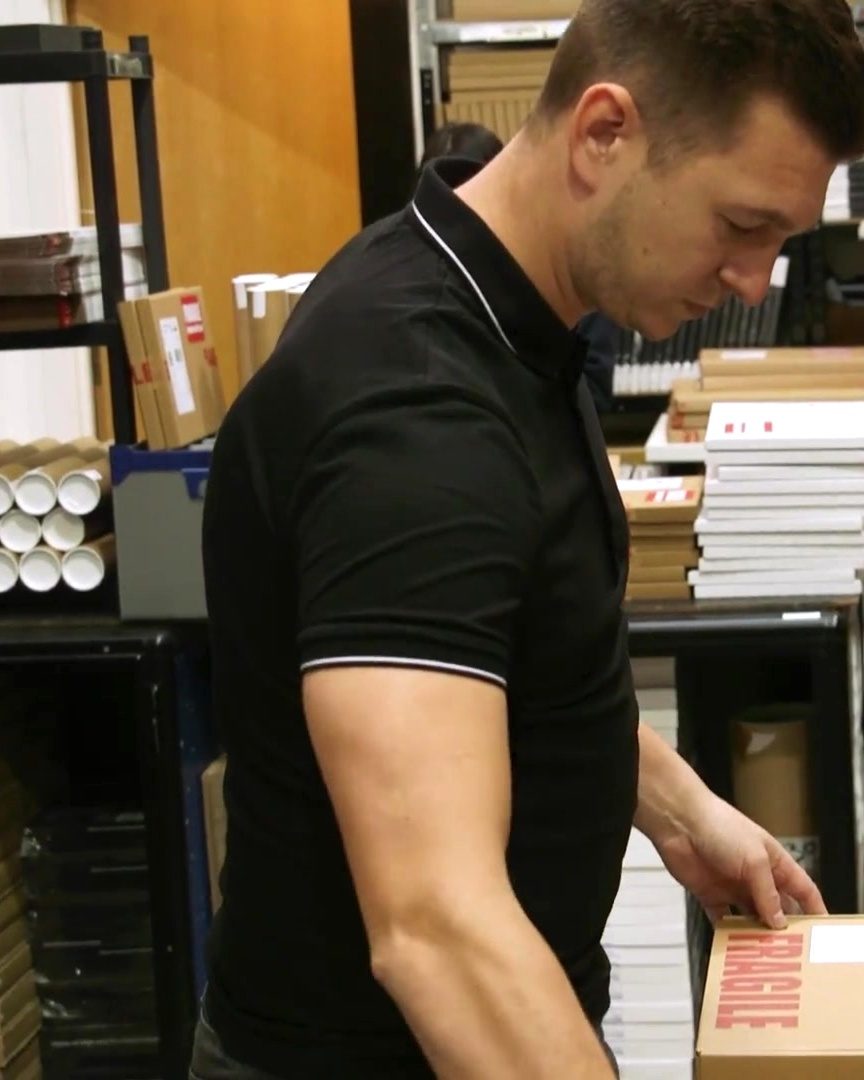 Rhys King, founder, packing orders in his fulfilment unit